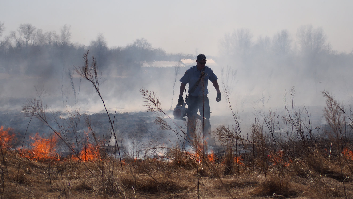 A Sedalia fireman battles a brushfire just south of the city limits near Craftsman Drive on Thursday, March 4, 2021.